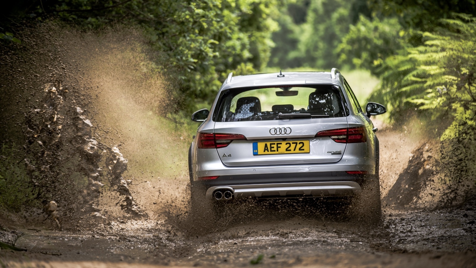 Silver Audi A4 driving in mud