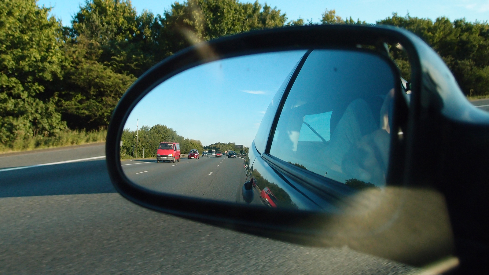 side mirror view driving on the motorway