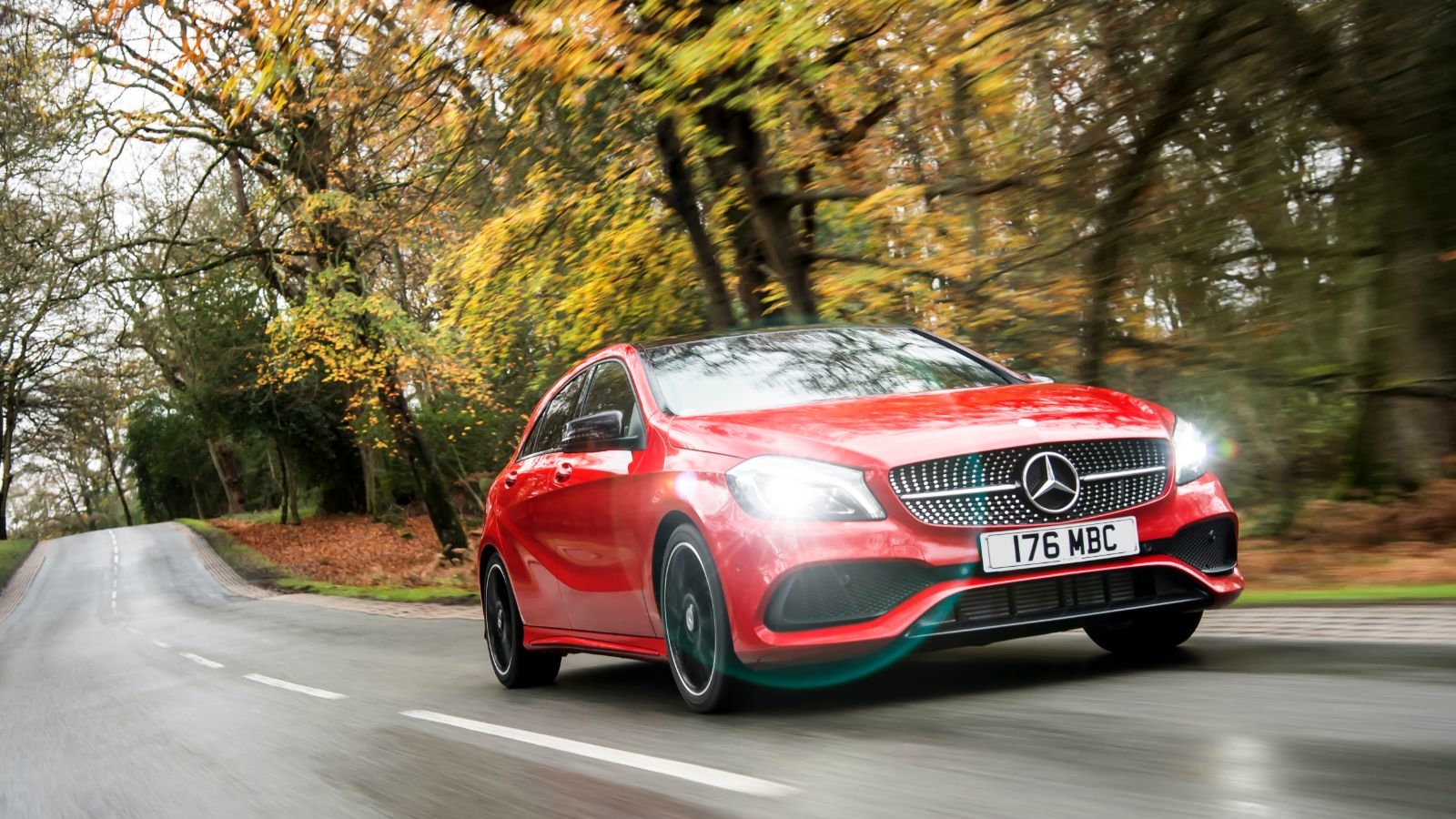 Red Mercedes-Benz A-Class front exterior with lights on